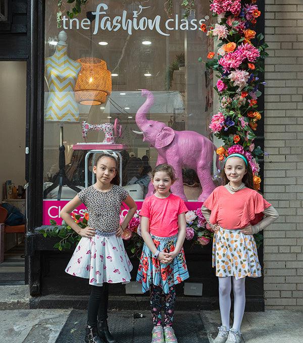Three girls posing at The Fashion Class entrance