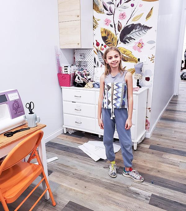 Girl standing in a sewing workshop