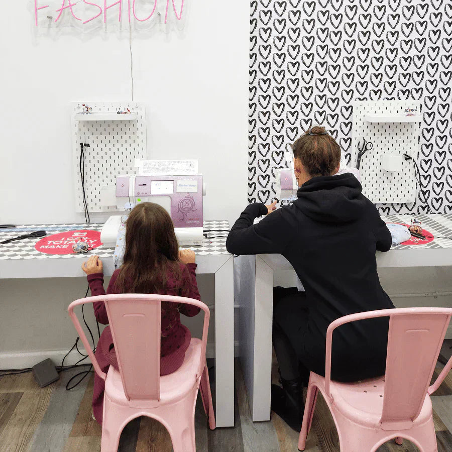 Mom and Kid working on a sewing machine