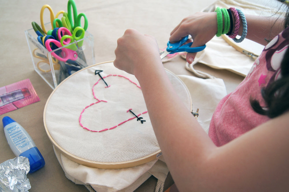 kid hand sewing heart shape