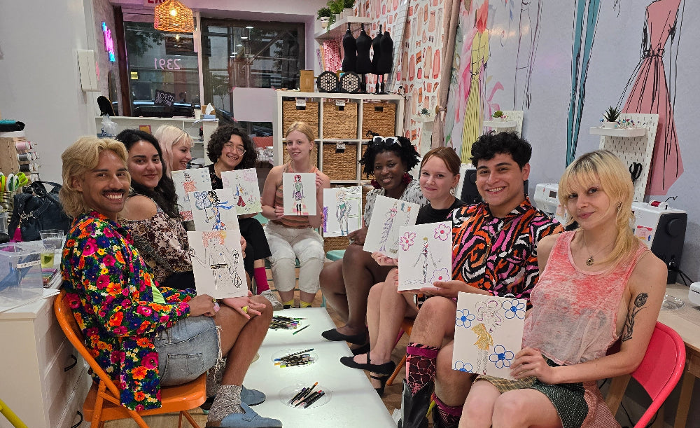Group of people sitting on colorful chairs in a room with artistic decor.