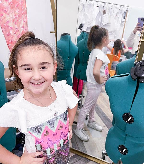 Girl standing with model display and mirror
